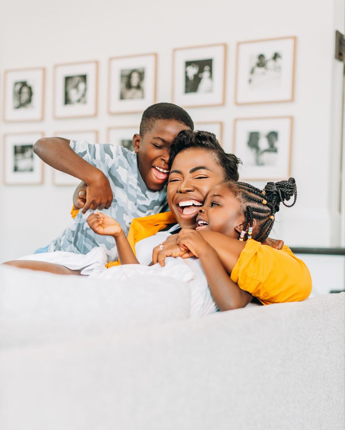 Happy mother and children laughing together at home