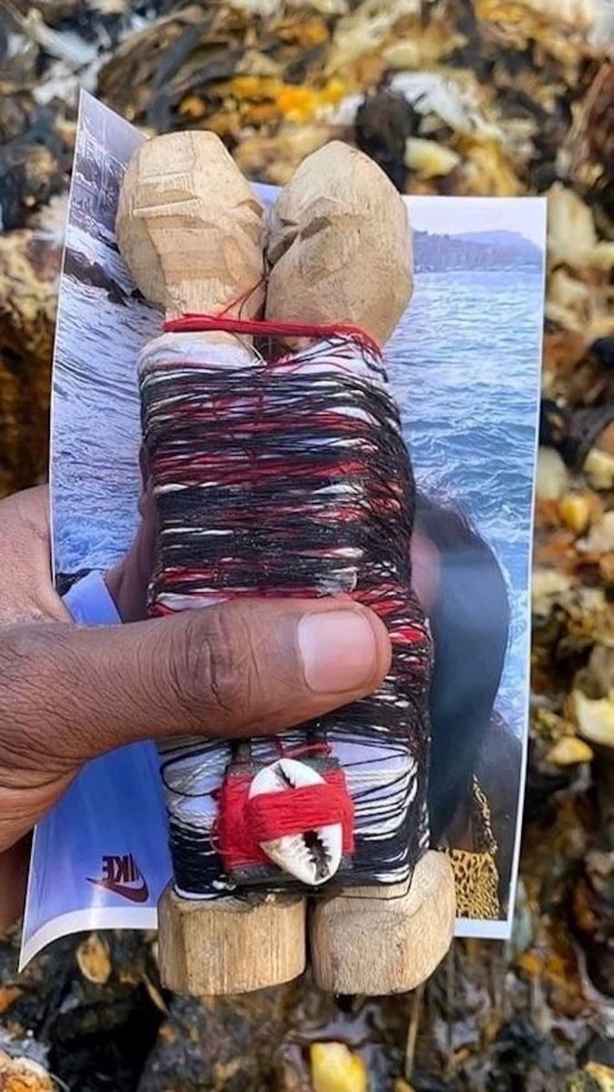 Traditional love binding ritual with carved wooden figures wrapped in thread