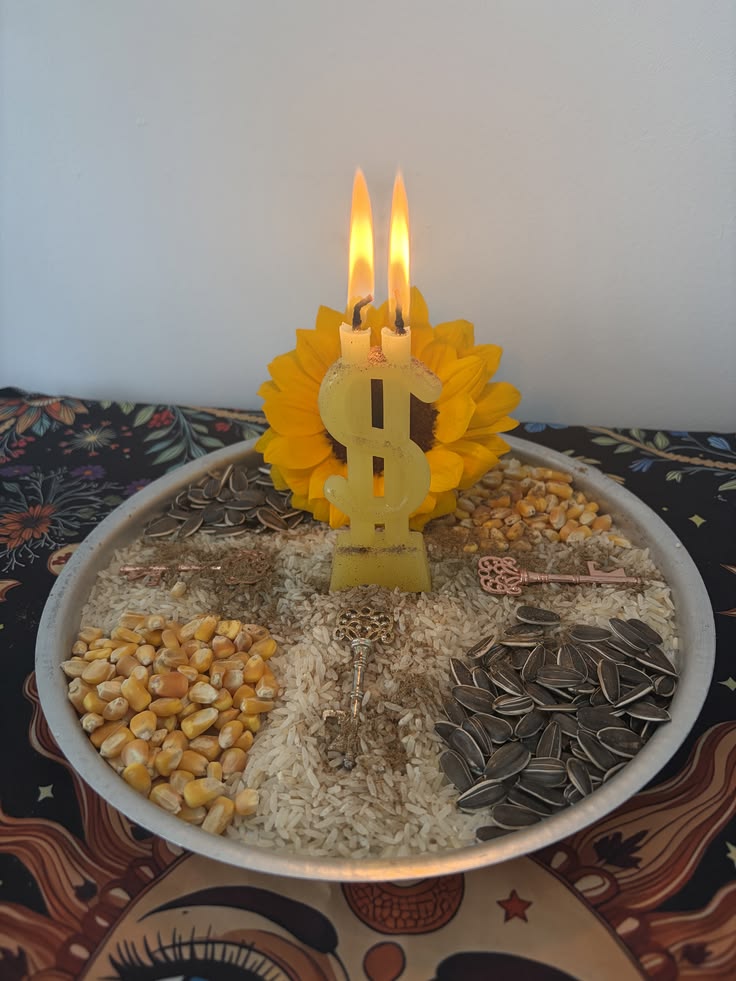 Prosperity candle on a plate of grains and seeds