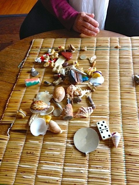 Spiritual reading with shells and bones on a woven mat